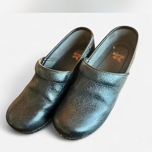 Dansko Black Floral Embossed Clogs